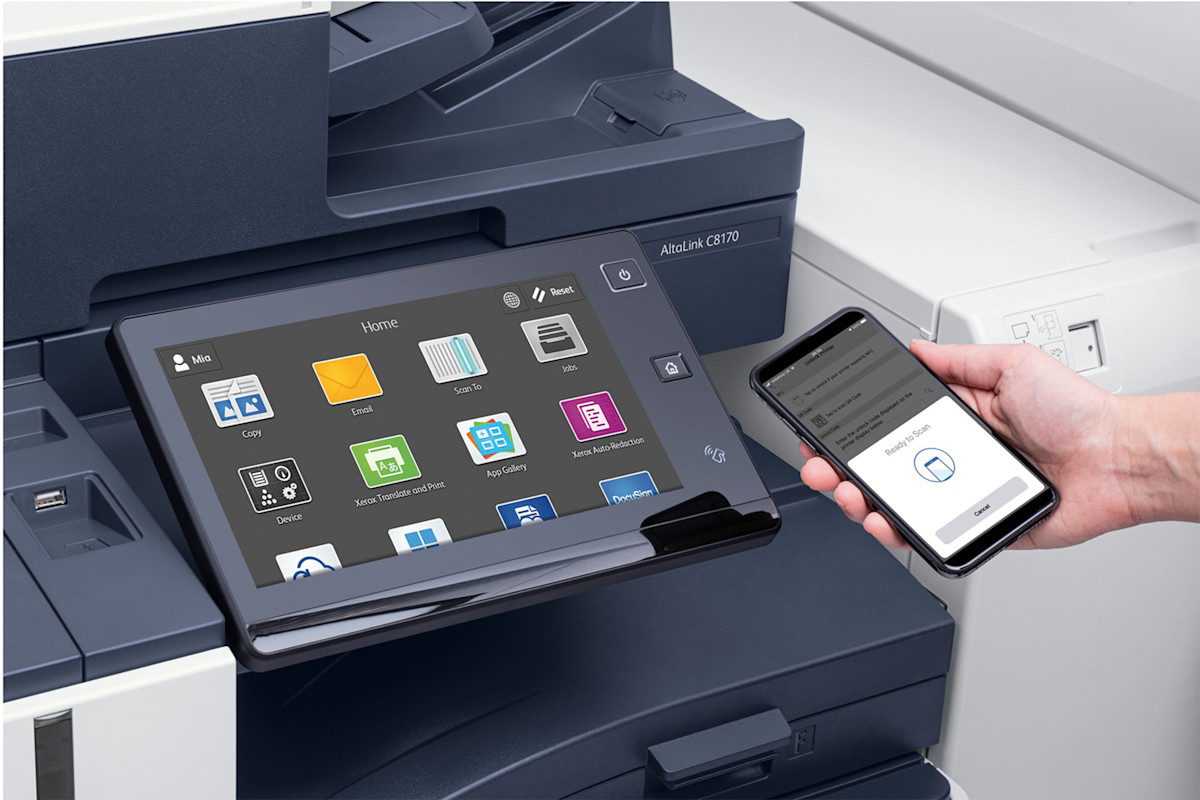Businesswoman using Xerox cloud-connected printer and tablet for data-driven print management with Nustream